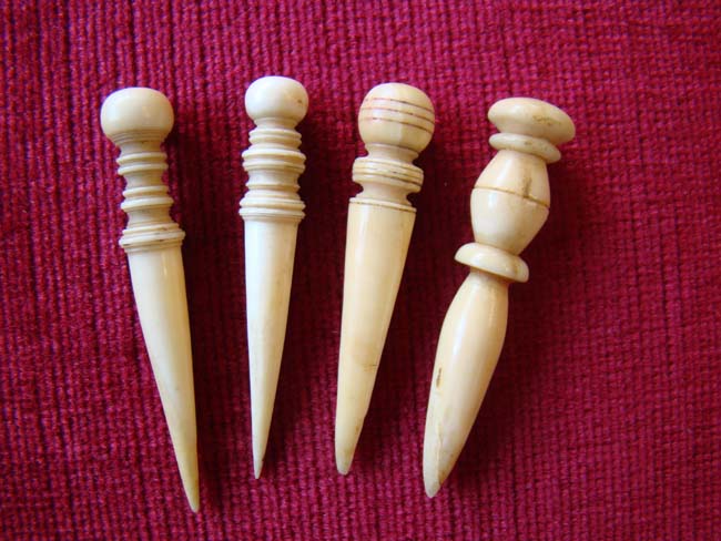 A very nice group of four 19th century sailor-made   whale ivory bodkins.